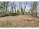 Large backyard with a wooden shelter and mature trees at 2049 Meador Se Ave, Atlanta, GA 30315