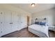 Spacious bedroom with wood-look floors and double doors leading to a bathroom at 2651 Stream Nw Ter, Atlanta, GA 30318