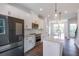 Modern kitchen featuring white cabinets, stainless steel appliances, and a large island at 2651 Stream Nw Ter, Atlanta, GA 30318