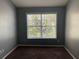 Simple bedroom with large window and brown carpet at 20 Pine Canyon Sw Dr # 41, Atlanta, GA 30331