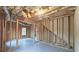 Unfinished basement with framed walls and a staircase at 1050 Wiley Bridge Rd, Woodstock, GA 30188