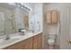 Clean bathroom with double vanity, shower, and overhead storage at 1050 Wiley Bridge Rd, Woodstock, GA 30188