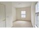 Simple bedroom with carpet, window, and double door closet at 1050 Wiley Bridge Rd, Woodstock, GA 30188