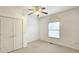 Well-lit bedroom featuring an arched window and a double-door closet at 1050 Wiley Bridge Rd, Woodstock, GA 30188