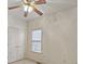 Bright bedroom with ceiling fan, double doors, and a window at 1050 Wiley Bridge Rd, Woodstock, GA 30188