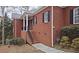 Brick home exterior with black shutters and steps leading to porch at 1050 Wiley Bridge Rd, Woodstock, GA 30188