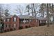 Brick house with a large covered porch and attached two-car garage at 1050 Wiley Bridge Rd, Woodstock, GA 30188