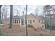 Tan house exterior with large windows and backyard view at 1050 Wiley Bridge Rd, Woodstock, GA 30188