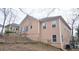 Tan house with deck, fenced yard, and mature trees at 1050 Wiley Bridge Rd, Woodstock, GA 30188