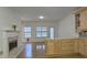 Open kitchen with island, wood cabinets, and breakfast area with a view to living room at 1050 Wiley Bridge Rd, Woodstock, GA 30188
