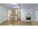 Kitchen boasts an island, wood cabinets, and a fireplace creating a warm atmosphere at 1050 Wiley Bridge Rd, Woodstock, GA 30188