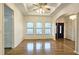 Living room with hardwood floors, coffered ceiling, and views of the kitchen at 1050 Wiley Bridge Rd, Woodstock, GA 30188