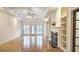 Spacious living room featuring hardwood floors, fireplace, built-in shelving, and abundant natural light at 1050 Wiley Bridge Rd, Woodstock, GA 30188