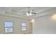 Main bedroom with tray ceiling, ceiling fan, and ensuite bath at 1050 Wiley Bridge Rd, Woodstock, GA 30188