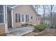 Rear patio with concrete slab and landscaping at 1050 Wiley Bridge Rd, Woodstock, GA 30188
