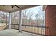 Porch with wooded view and decorative railing at 1050 Wiley Bridge Rd, Woodstock, GA 30188