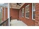 Covered porch with ceiling fan and wrought iron railing at 1050 Wiley Bridge Rd, Woodstock, GA 30188