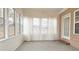Sunroom with multiple windows and neutral carpeting at 1050 Wiley Bridge Rd, Woodstock, GA 30188