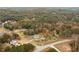 Aerial view showing house nestled in a wooded landscape with nearby homes visible at 100 Percheron Dr, Canton, GA 30114