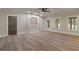 Large basement recreation room with built-in shelving and hardwood floors at 100 Percheron Dr, Canton, GA 30114