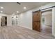 Finished basement featuring a barn door and an open floor plan at 100 Percheron Dr, Canton, GA 30114