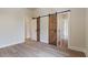 Bright bedroom featuring barn doors and hardwood floors at 100 Percheron Dr, Canton, GA 30114