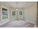 Bright breakfast nook with three windows and a modern light fixture at 100 Percheron Dr, Canton, GA 30114