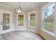 Breakfast nook with three windows, hardwood floors, and a modern chandelier at 100 Percheron Dr, Canton, GA 30114