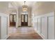 Hardwood floors, white wainscoting, and double doors leading into the home at 100 Percheron Dr, Canton, GA 30114