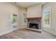 Stone fireplace with wooden mantel in a bright and airy room at 100 Percheron Dr, Canton, GA 30114