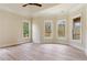 Bright main bedroom with hardwood floors, tray ceiling, and multiple windows at 100 Percheron Dr, Canton, GA 30114