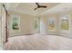 Spacious main bedroom with hardwood floors, tray ceiling, and barn door to en-suite bath at 100 Percheron Dr, Canton, GA 30114