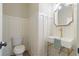 Elegant powder room with white shiplap walls, gold fixtures, and a stylish pedestal sink at 100 Percheron Dr, Canton, GA 30114