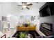 Living room with mustard sofa, fireplace, and ceiling fan at 110 Cobalt Dr, Fayetteville, GA 30214