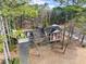 Aerial view of a two-story brick home with a long driveway and mature trees at 1579 Howell Highlands Dr, Stone Mountain, GA 30087