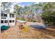 View of backyard with an outdoor kitchen and a large patio area with ample space for entertaining at 1579 Howell Highlands Dr, Stone Mountain, GA 30087