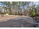 Backyard featuring a spacious basketball court, shed, and screened gazebo surrounded by towering trees at 1579 Howell Highlands Dr, Stone Mountain, GA 30087