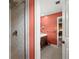 Bright bathroom featuring a tile shower, vanity and coral paint at 1579 Howell Highlands Dr, Stone Mountain, GA 30087