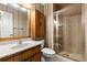 Bathroom featuring a glass-enclosed shower and decorative wallpaper at 1579 Howell Highlands Dr, Stone Mountain, GA 30087