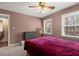 Bedroom featuring a bed, dresser, ceiling fan, and windows for plenty of natural light at 1579 Howell Highlands Dr, Stone Mountain, GA 30087