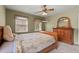 Bedroom featuring a dresser, multiple windows, soft carpet, and a wooden bed frame at 1579 Howell Highlands Dr, Stone Mountain, GA 30087