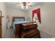 Neutral bedroom featuring a wooden dresser and a bed with bright blue decorative pillows at 1579 Howell Highlands Dr, Stone Mountain, GA 30087