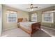 Bedroom featuring multiple windows, soft carpet, and a wooden bed frame at 1579 Howell Highlands Dr, Stone Mountain, GA 30087