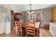 Dining room with hardwood floors, chandelier, and adjacent kitchen and living areas at 1579 Howell Highlands Dr, Stone Mountain, GA 30087