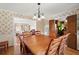 Dining room with hardwood floors, chandelier, and view to the living room at 1579 Howell Highlands Dr, Stone Mountain, GA 30087