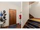 View of the entryway with wooden front door, stairs, and hat rack with modern decor at 1579 Howell Highlands Dr, Stone Mountain, GA 30087