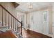 Elegant foyer with hardwood floors, staircase, and decorative wallpaper at 1579 Howell Highlands Dr, Stone Mountain, GA 30087