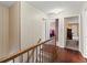 Upstairs hallway with hardwood floors and views into other bedrooms at 1579 Howell Highlands Dr, Stone Mountain, GA 30087