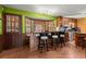 Kitchen with dark cabinets, bar with seating and a wooden exterior door with window pane at 1579 Howell Highlands Dr, Stone Mountain, GA 30087