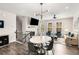 Modern dining area with white round table, six chairs, and hardwood floors at 1590 Ridgebrook Downs, Mableton, GA 30126